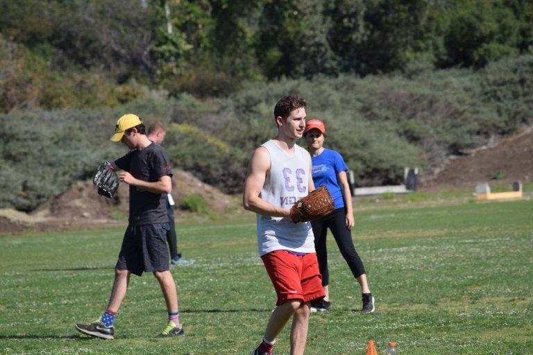 Pitzer students change sides during a softball game